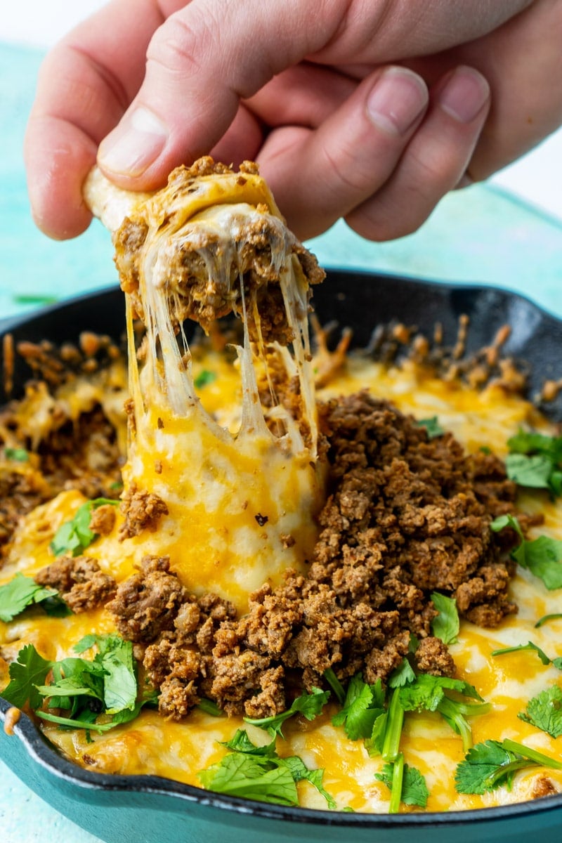 Chip dipped in queso fundido