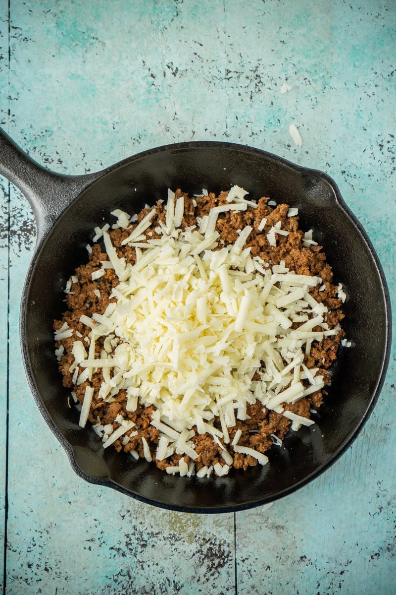 cheese on top of chorizo in queso fundido