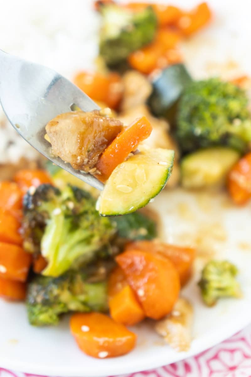 Individual bite of teriyaki chicken and veggies