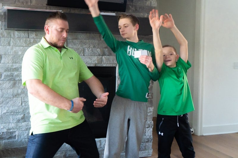 Family acting out a rainbow in St. Patrick's Day charades