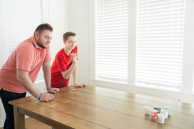 son and father playing valentines minute to win it games