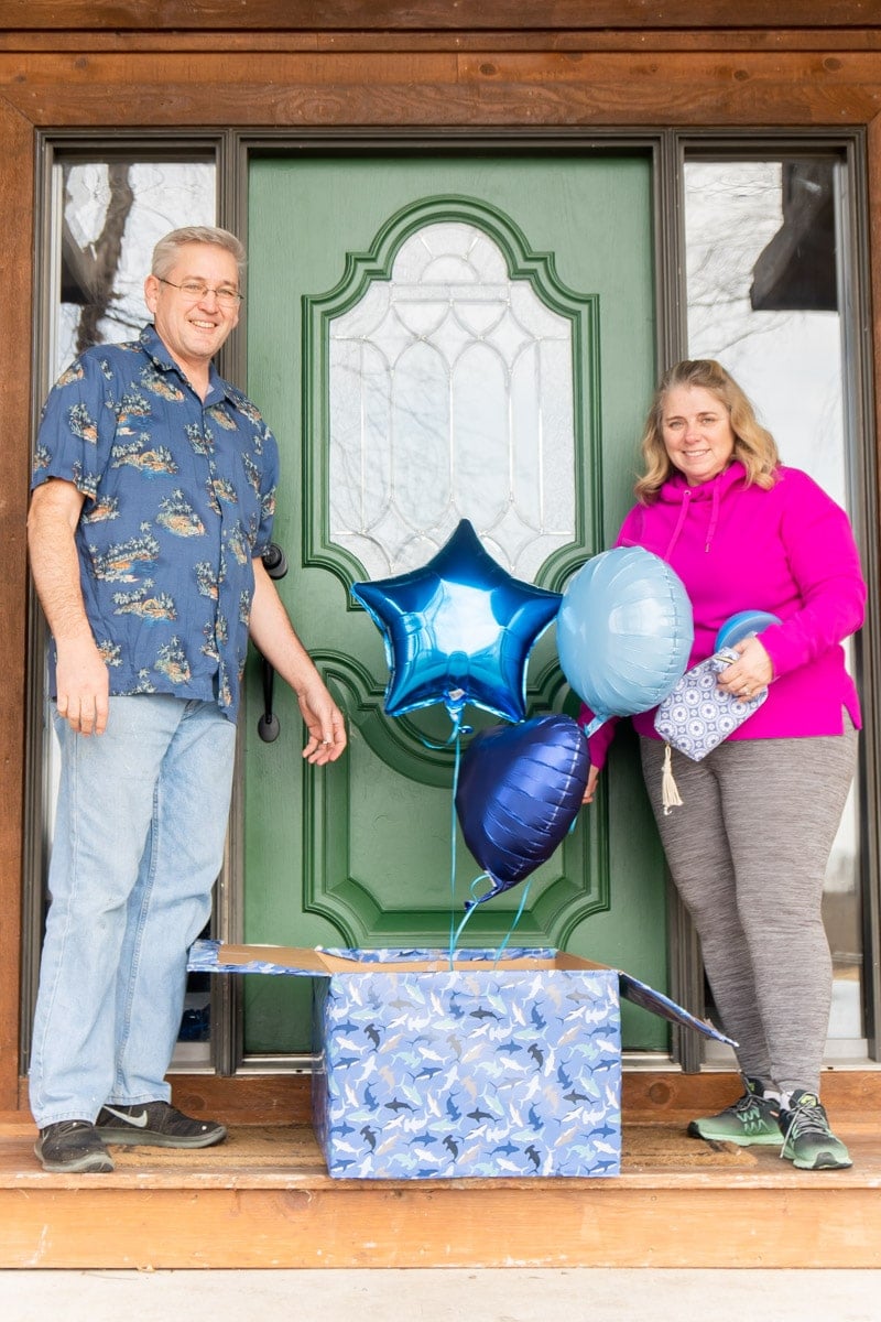 Grandparents holding blue gifts