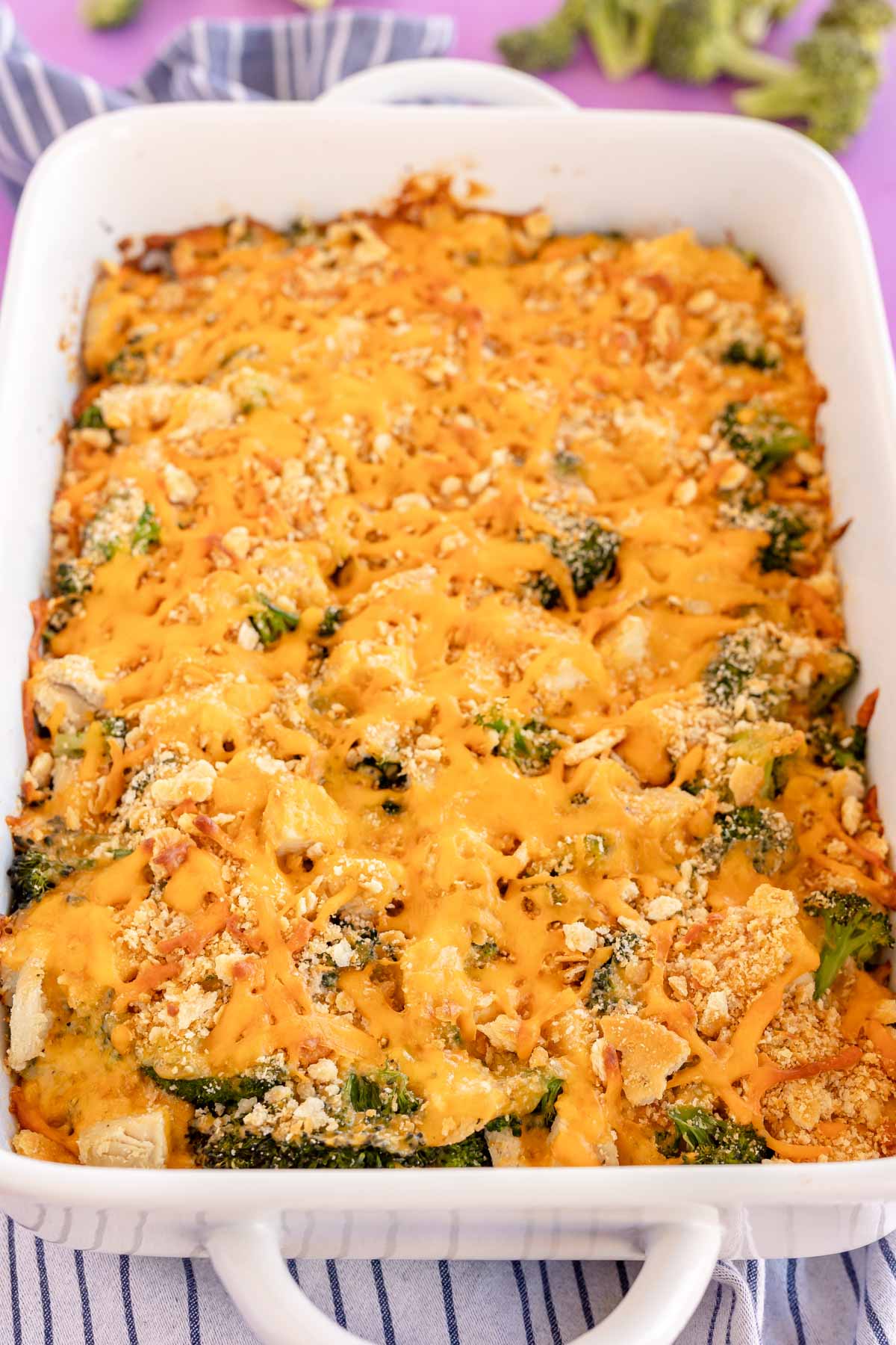 wooden spoon in a casserole dish with broccoli chicken casserole