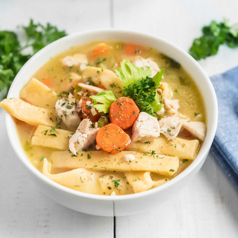 chicken noodle soup in a white bowl