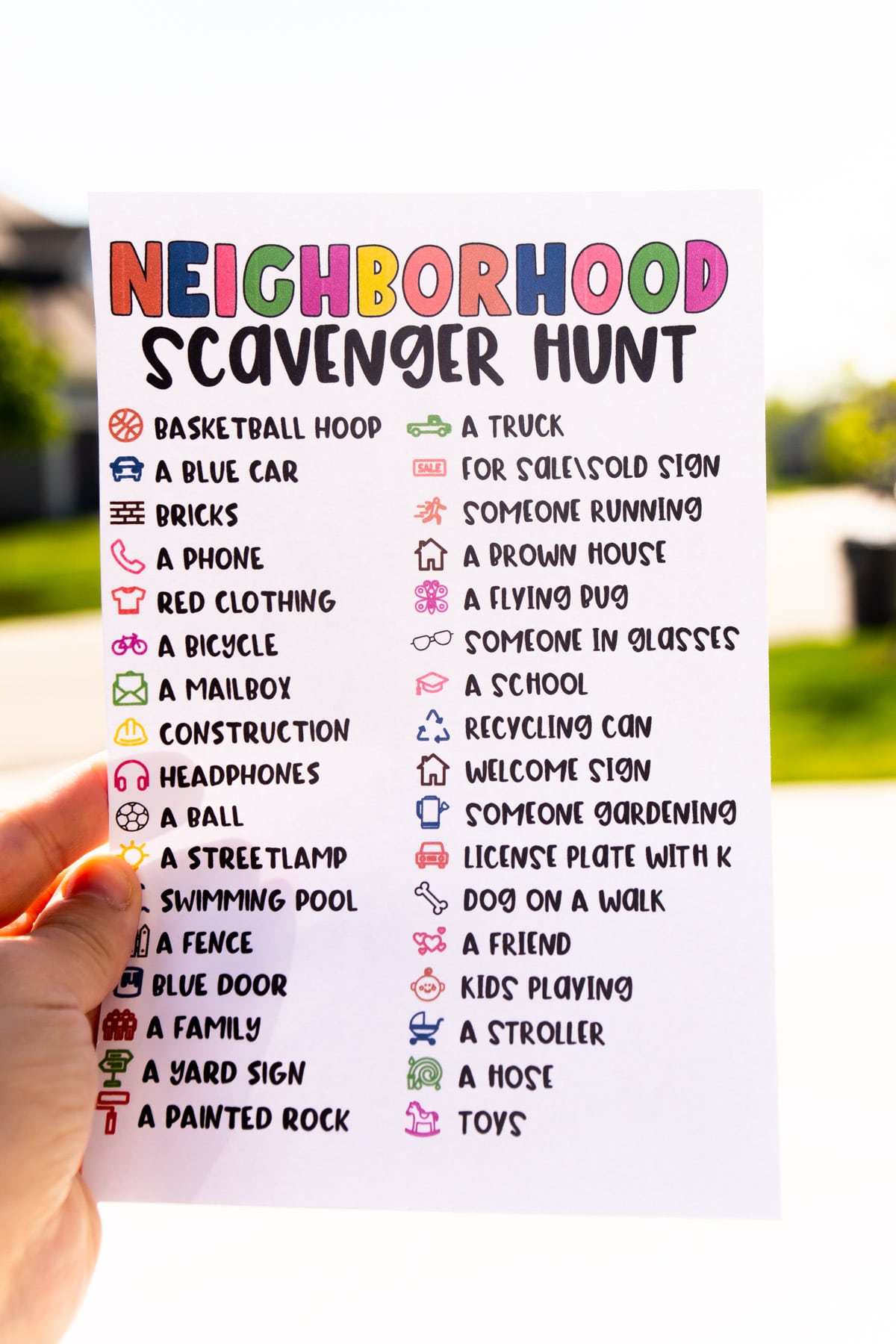 Person holding a neighborhood scavenger hunt outside