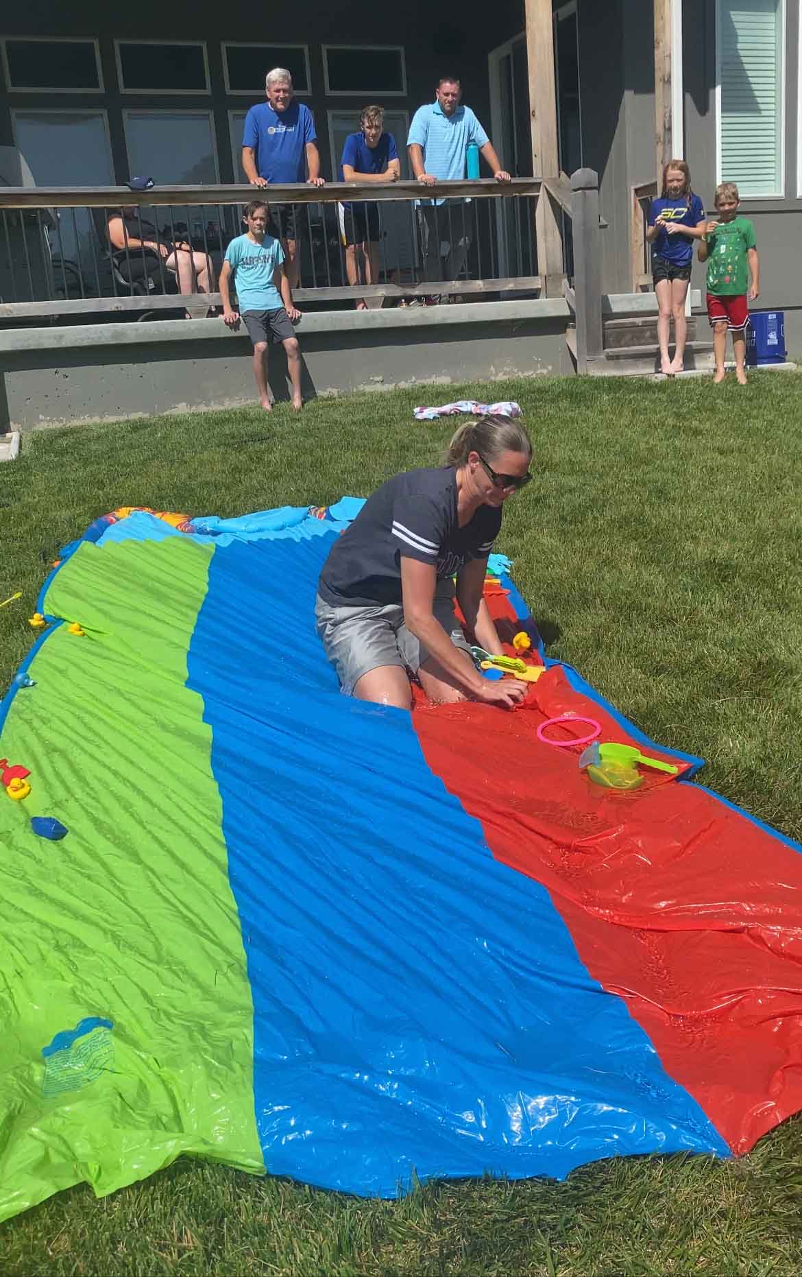 woman sliding down a slip n slide