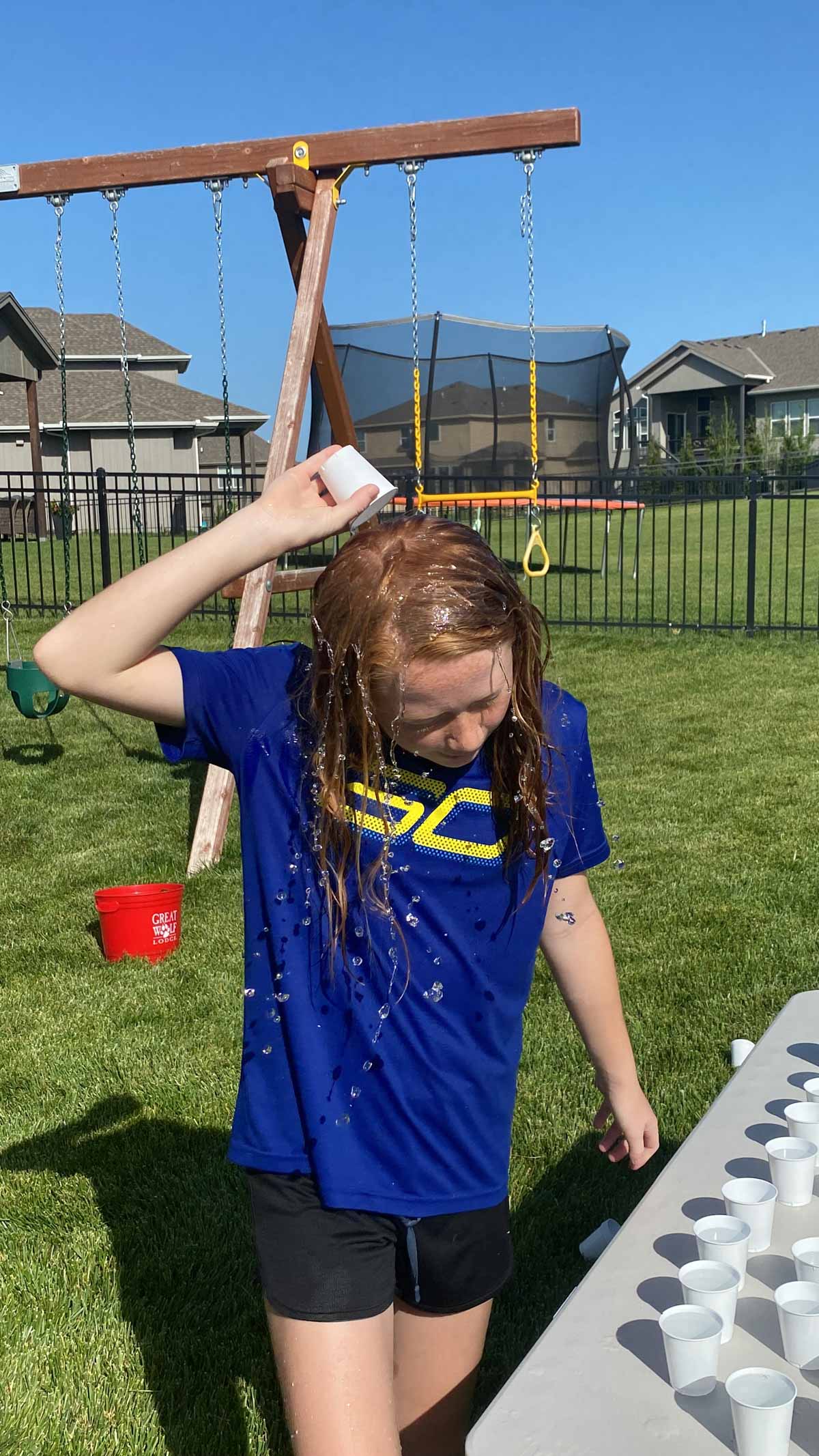 girl pouring water over her head