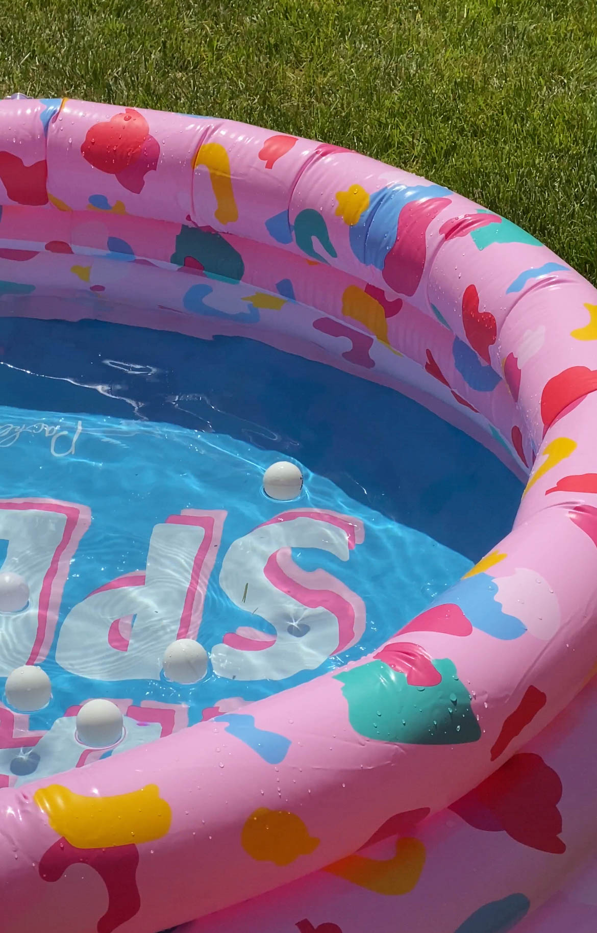 kiddie pool filled with ping pong balls