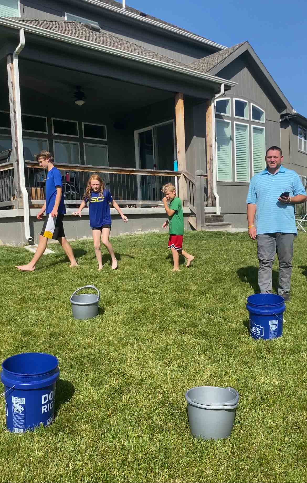 people standing around buckets