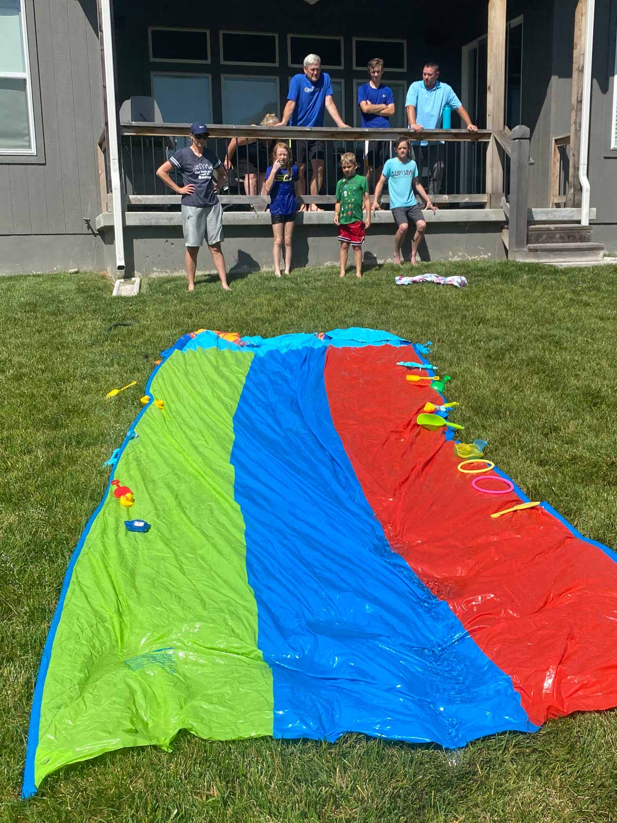 slip n slide with pool toys on it