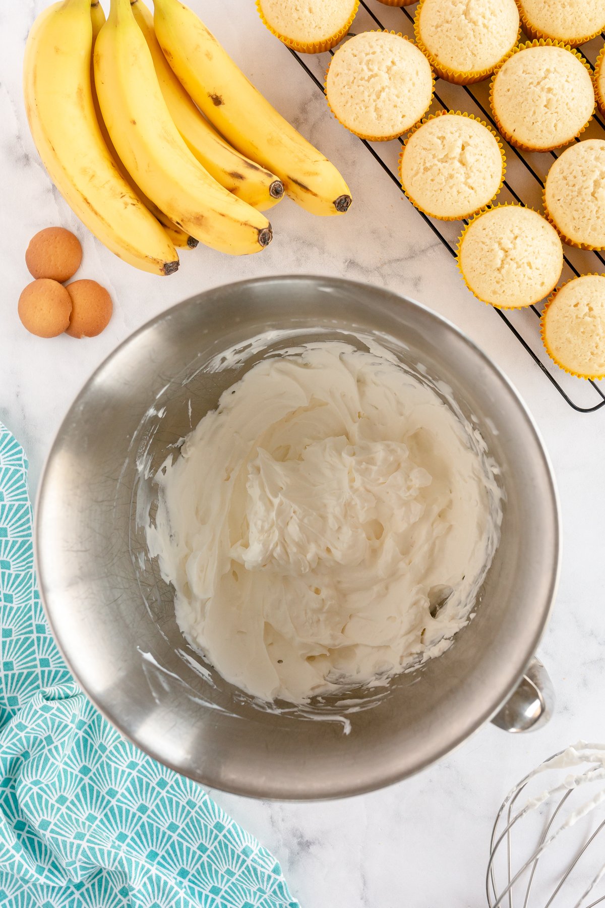 metal mixing bowl with whipped cream frosting