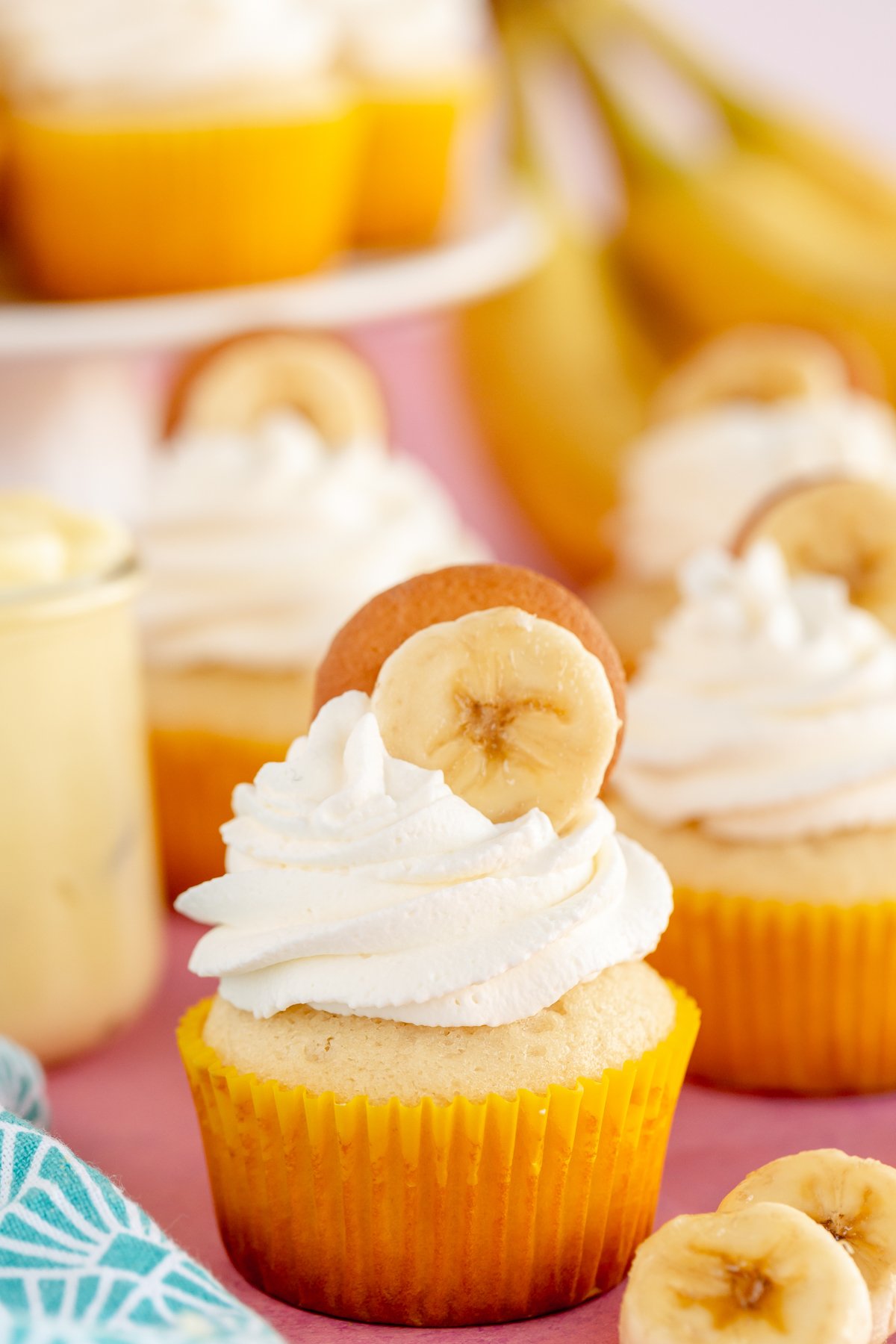 banana pudding cupcake topped with whipped cream frosting and a vanilla wafer