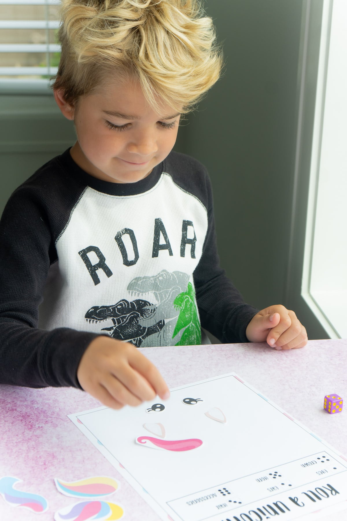 Boy playing roll a unicorn game