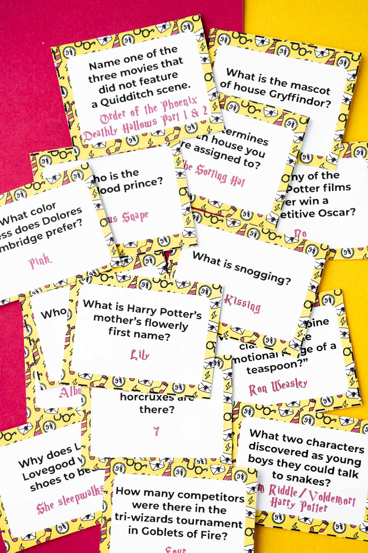 A pile of yellow Harry Potter trivia cards on a piece of yellow and red paper