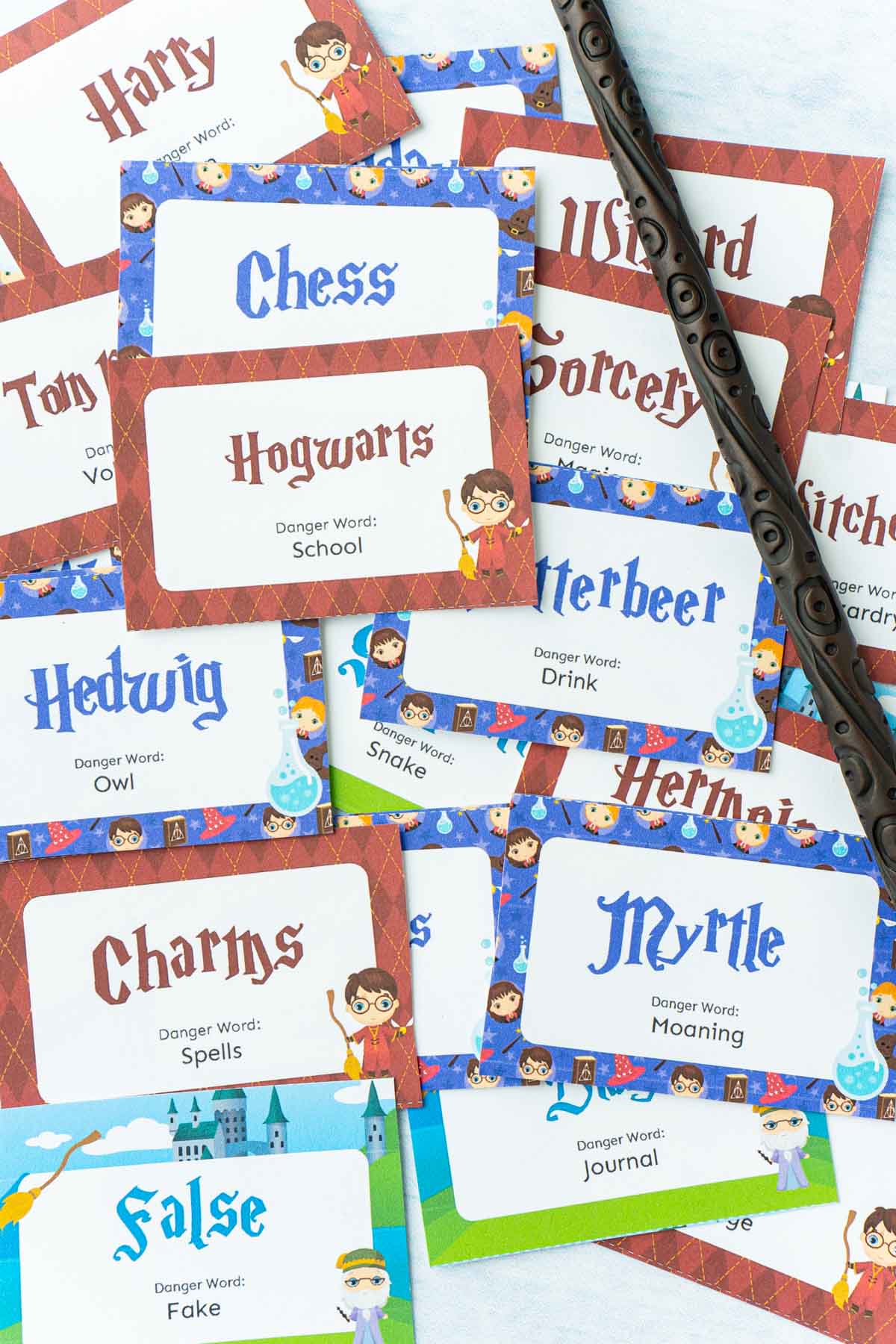 A bunch of little cards with Harry Potter words and pictures on them and a wand