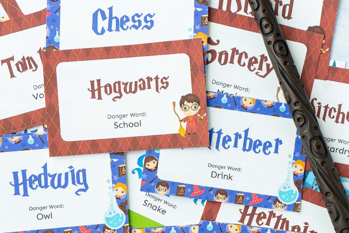 A bunch of little cards with Harry Potter words and pictures on them and a wand