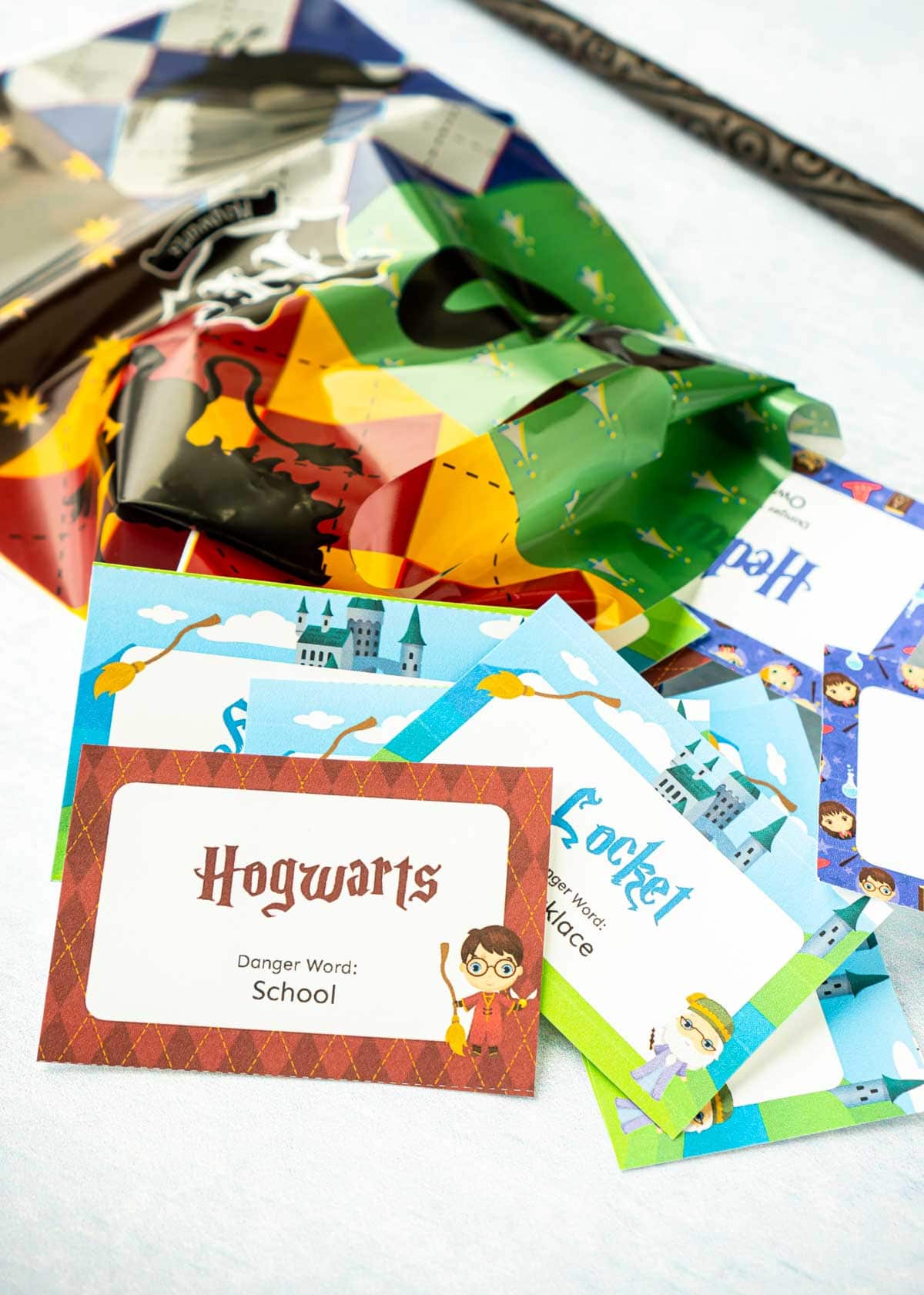 Small paper cards with Harry Potter phrases on them and a Harry Potter goodie bag