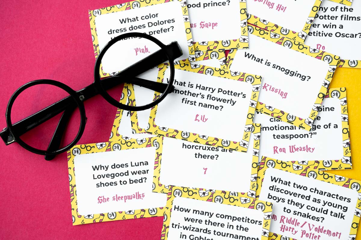 Pile of Harry Potter trivia questions with a yellow background and a pair of plastic glasses