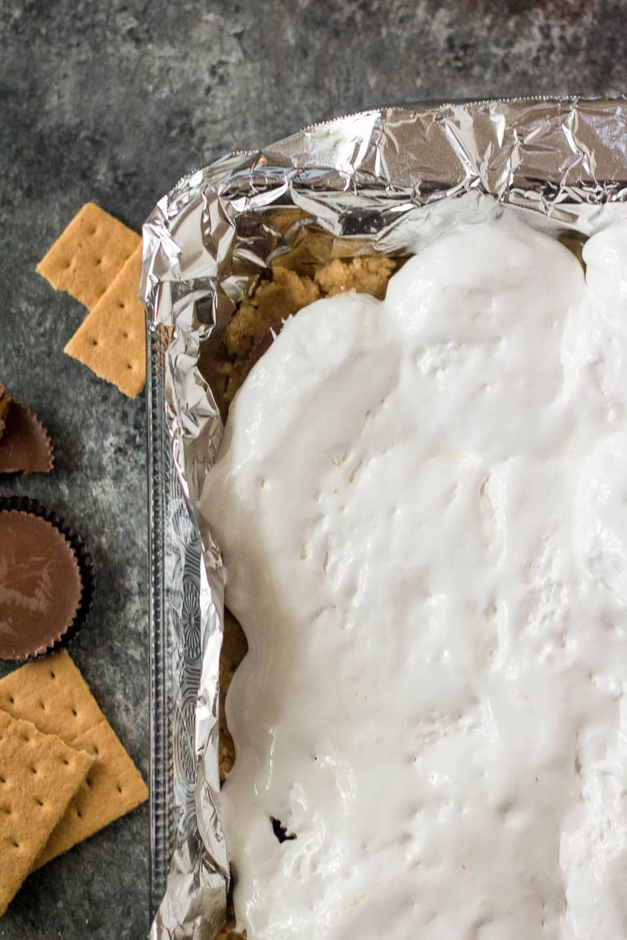 Marshmallow fluff in a baking dish with tin foil