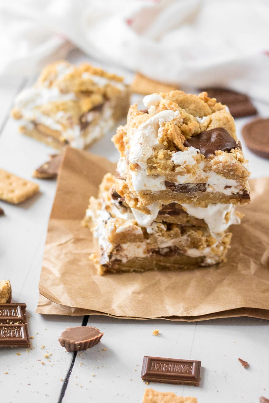 Three stacked smore bars on a brown napkin