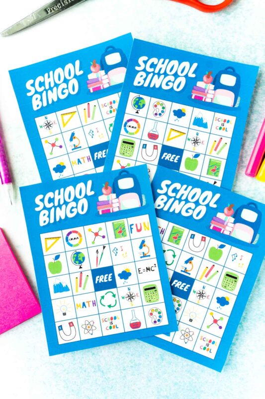 Four blue back to school bingo cards with school images on them