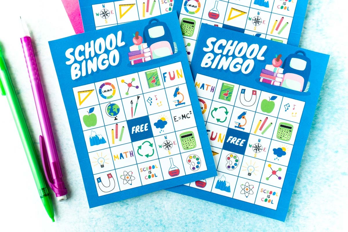 Four blue bingo cards with two pencils