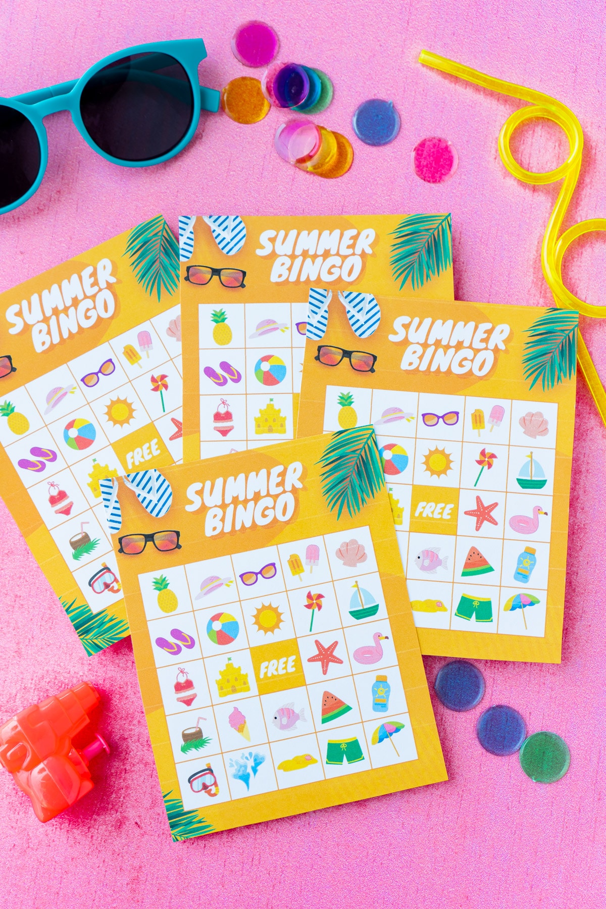 Four orange summer bingo cards with sunglasses and bingo markers