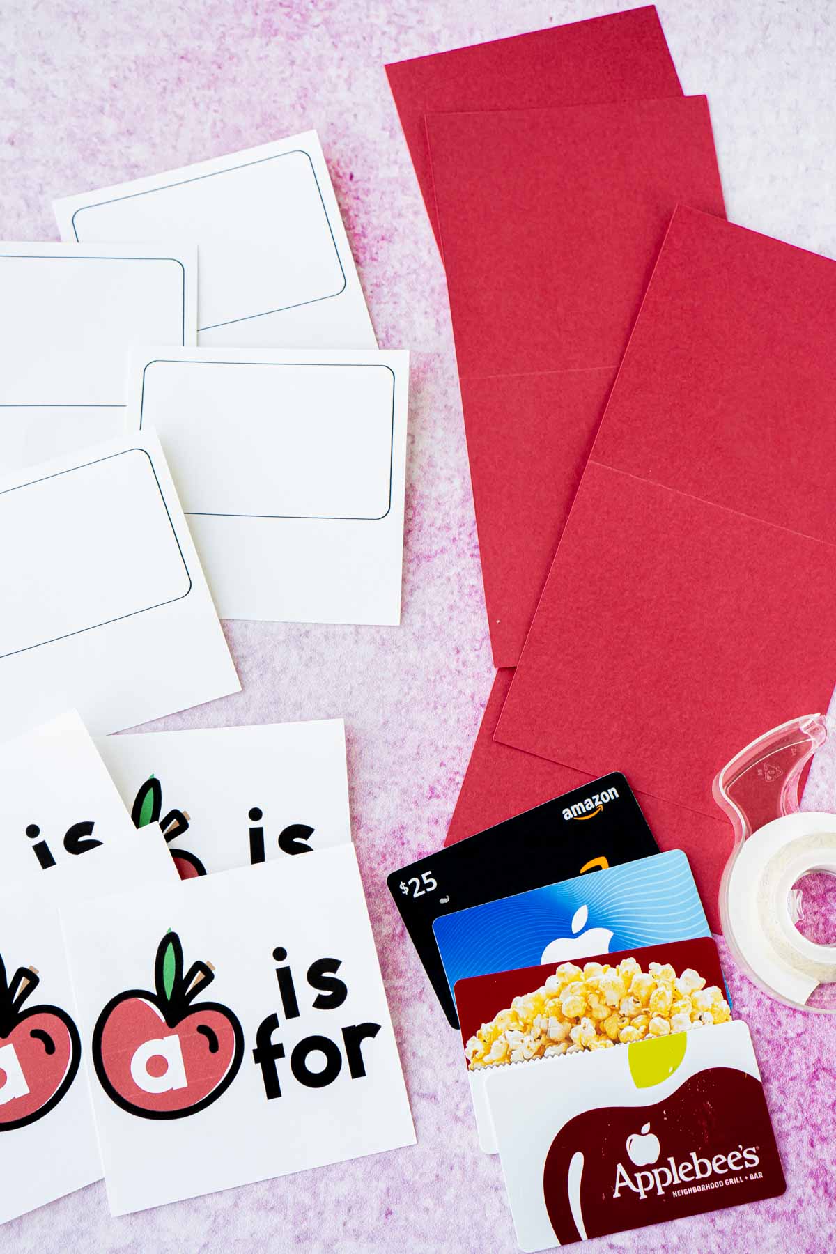 Apple cards, gift cards, and red cardstock in a flat lay