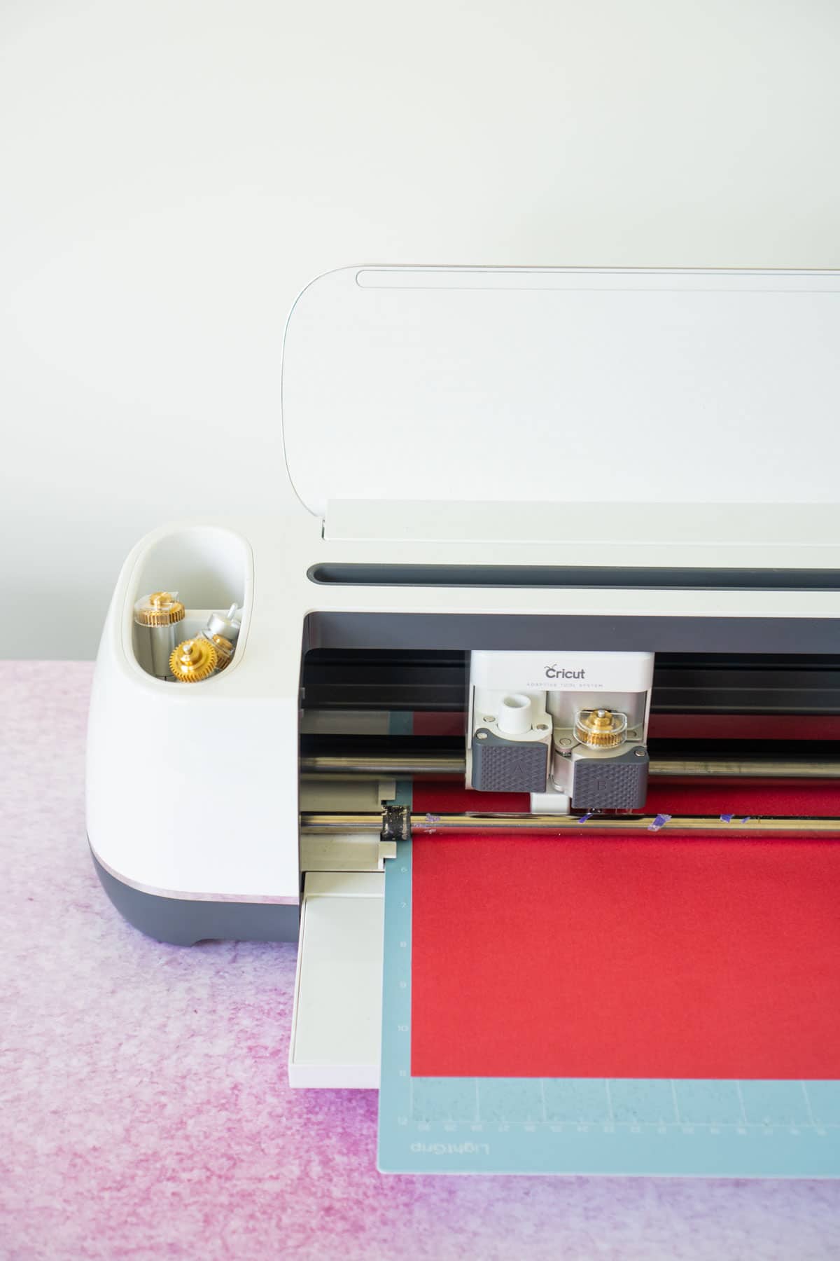 Cricut Maker cutting a piece of red cardstock