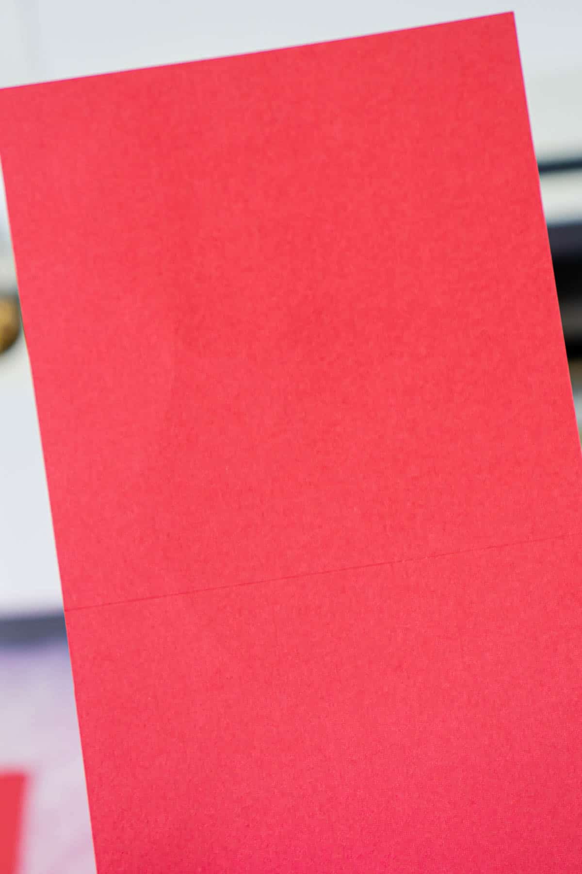 Piece of red cardstock with score lines