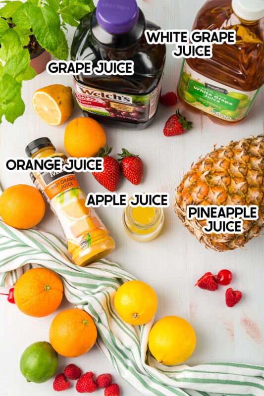 Tons of fruit and bottles of juice on a white background