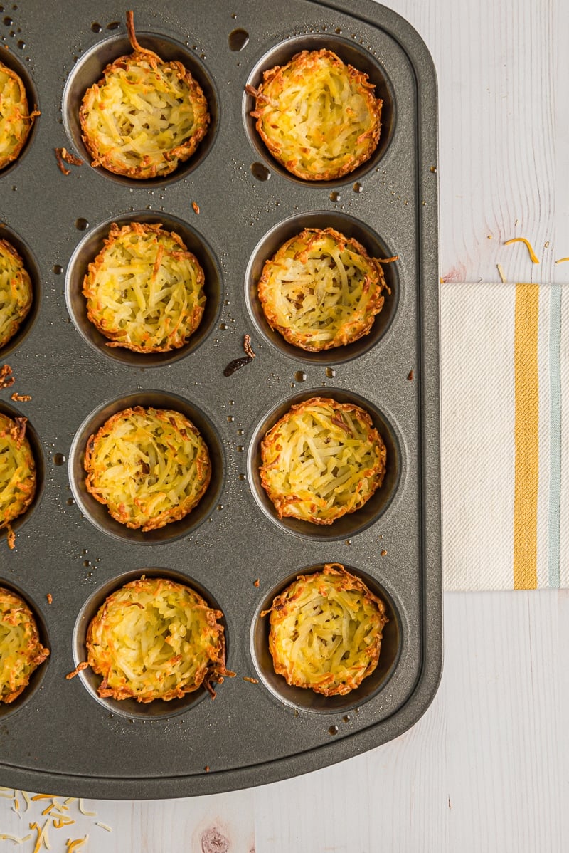 Browned hash brown cups in a muffin tin