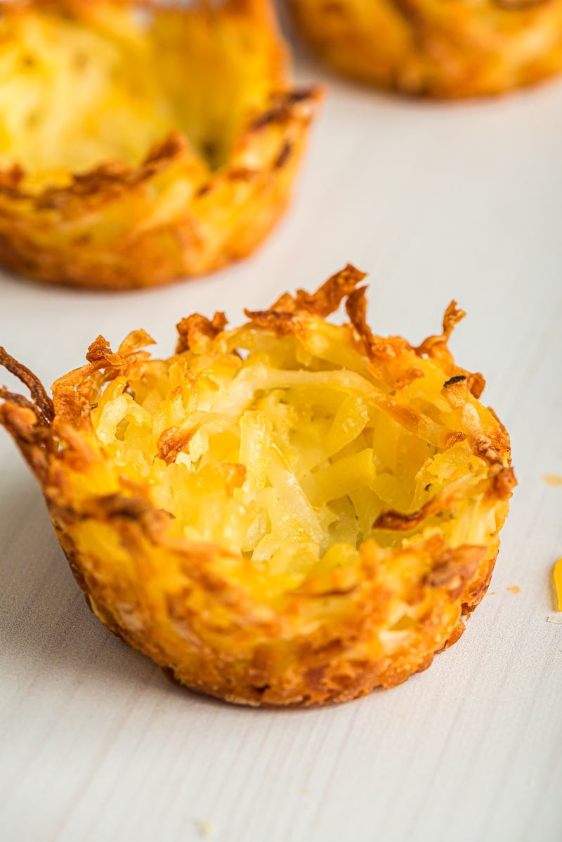 Three hash brown cups sitting on a white table