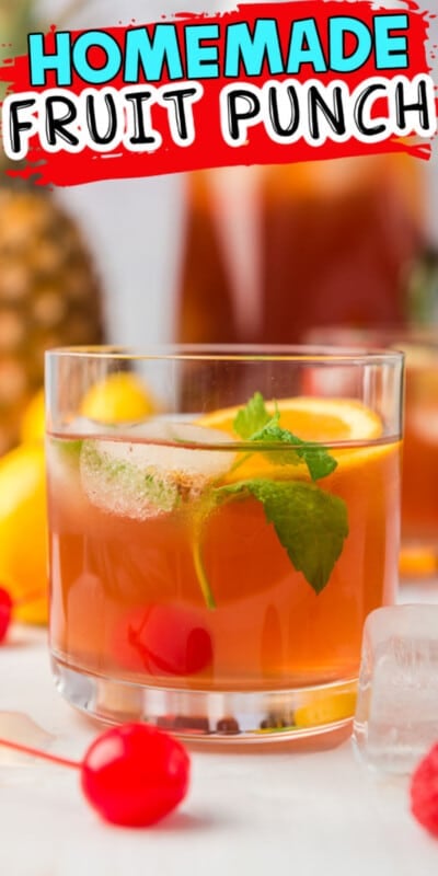 Glass of fruit punch in front of a pitcher of fruit punch with fruit all around with text for Pinterest