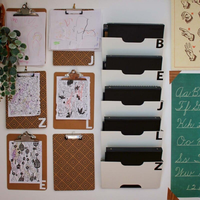 Clipboards and file folders on the wall with colorful sheets of paper