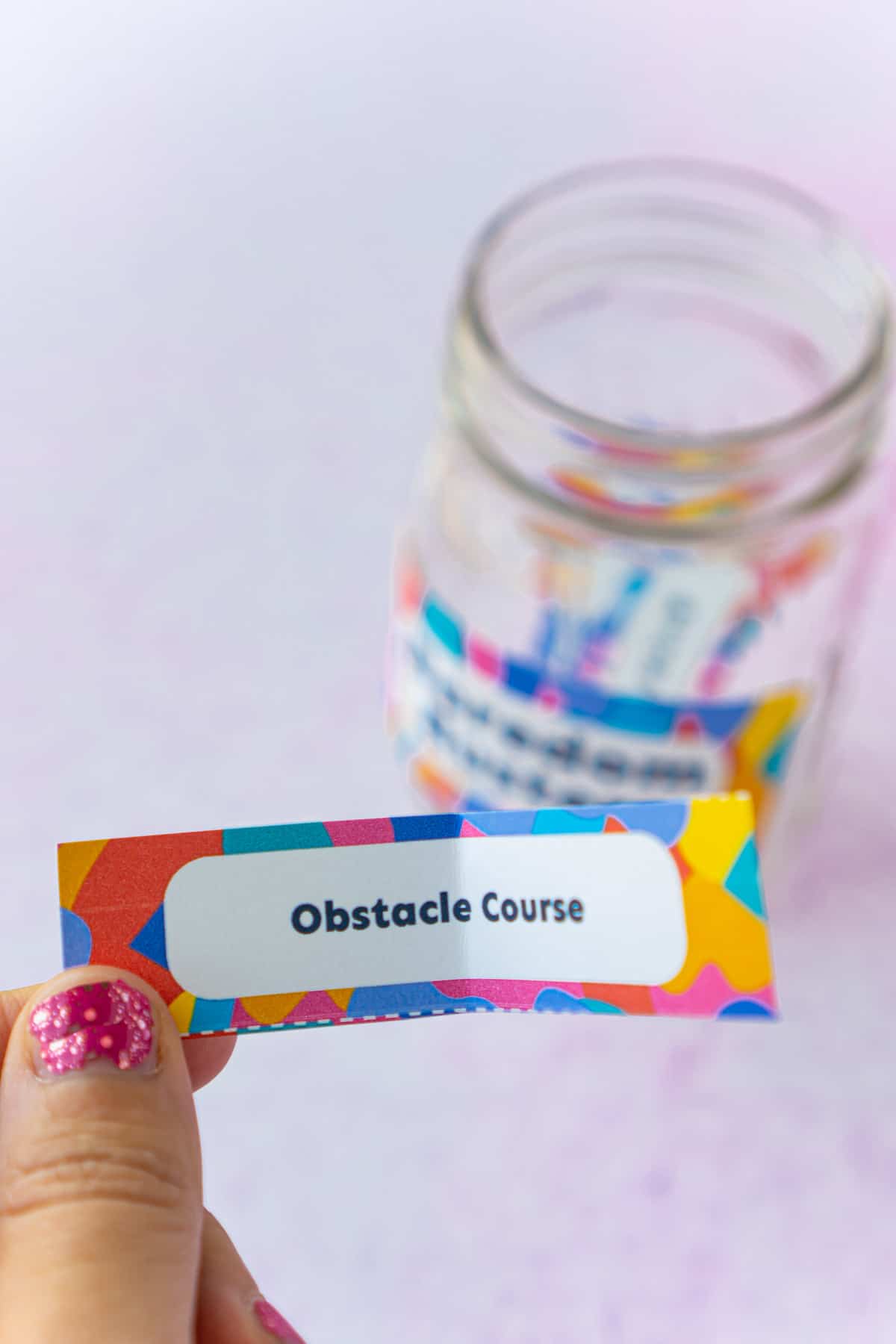 A woman's hand holding a piece of paper that says obstacle course