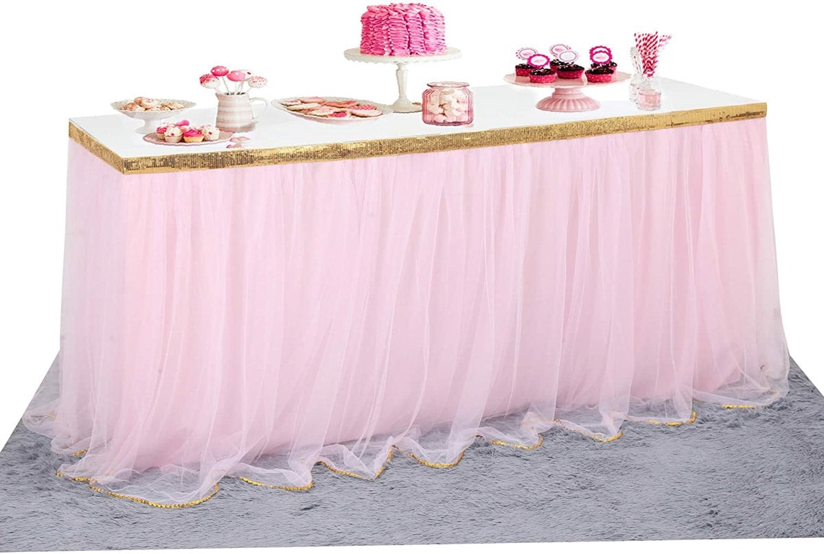 a pink tulle table skirt with pink items on the table