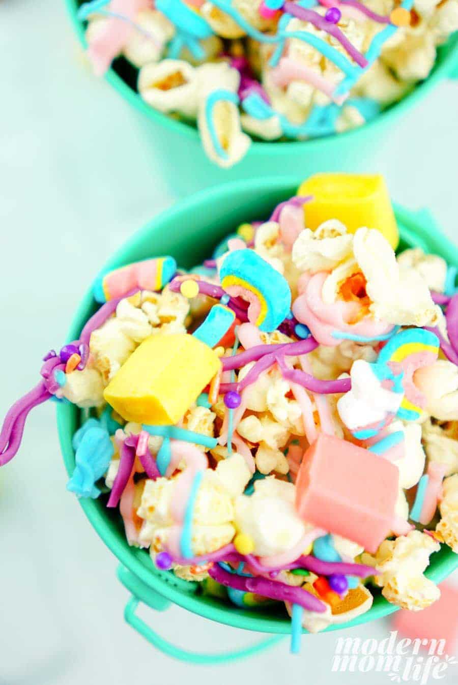 Green bucket filled with colorful unicorn popcorn snack