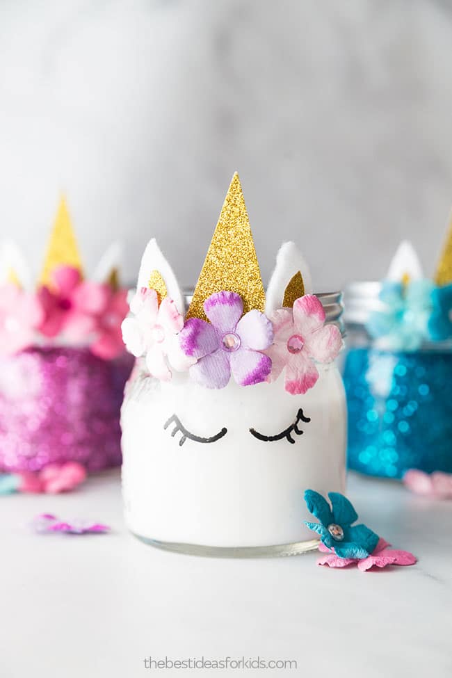 White unicorn decorated jar of slime with other colors in the background