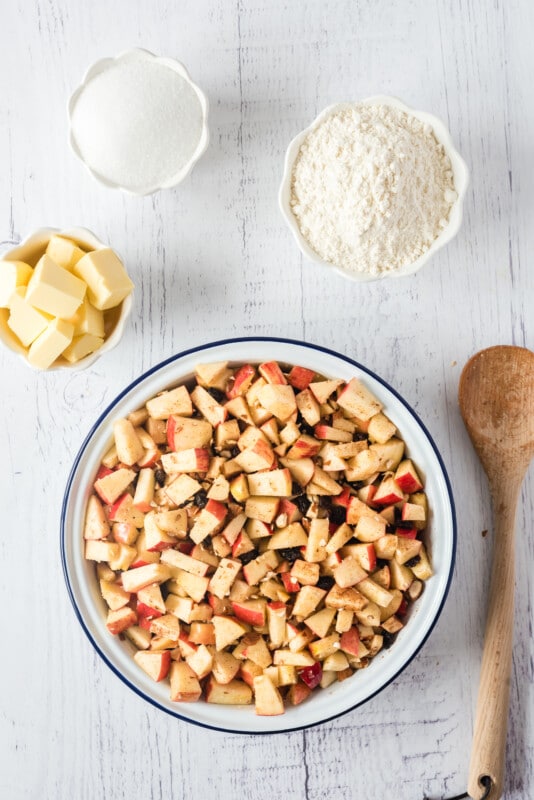 A bowl of chopped apples with flour around it