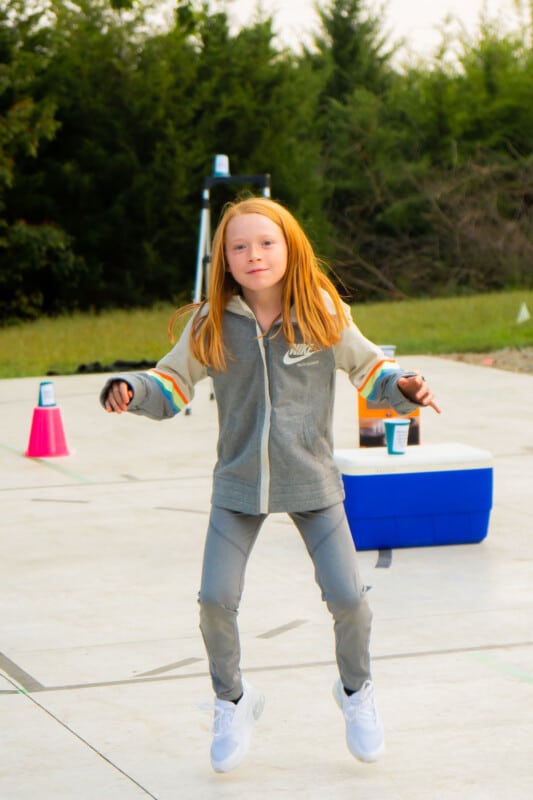 Girl on her toes in a gray sweatsuit