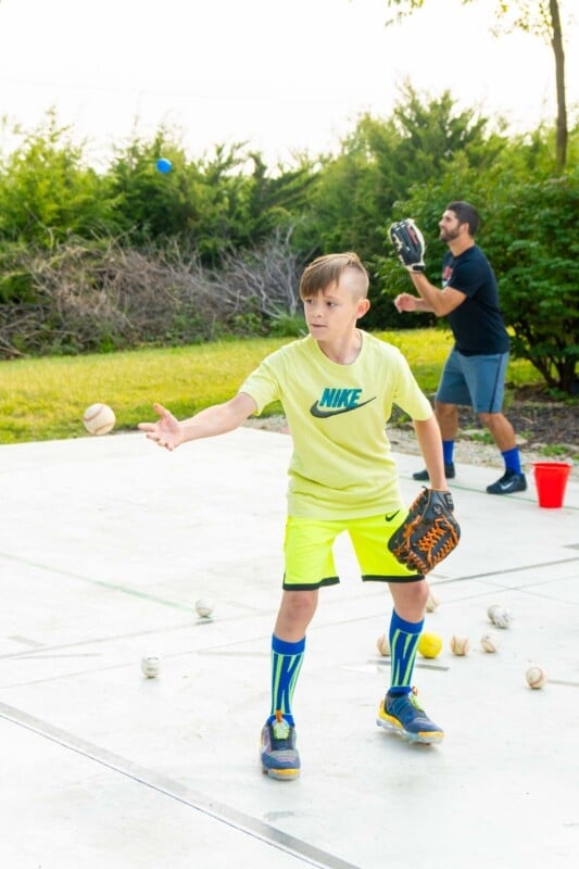 Kid in yellow clothes fielding a baseball