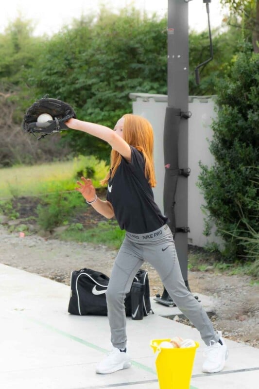 Girl catching a baseball in a glove