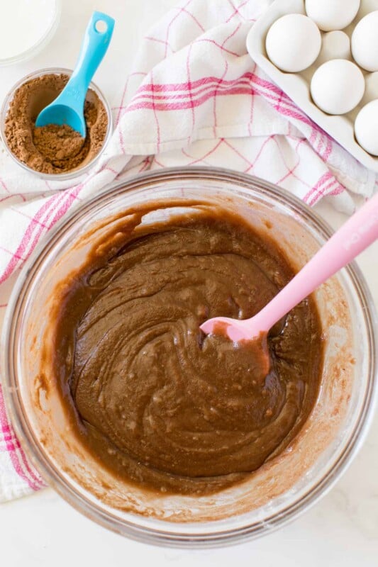 Glass bowl with batter for chocolate brownie cake inside