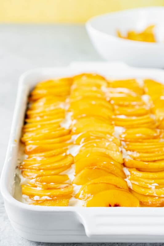 Peach cake in a white rectangle cake dish