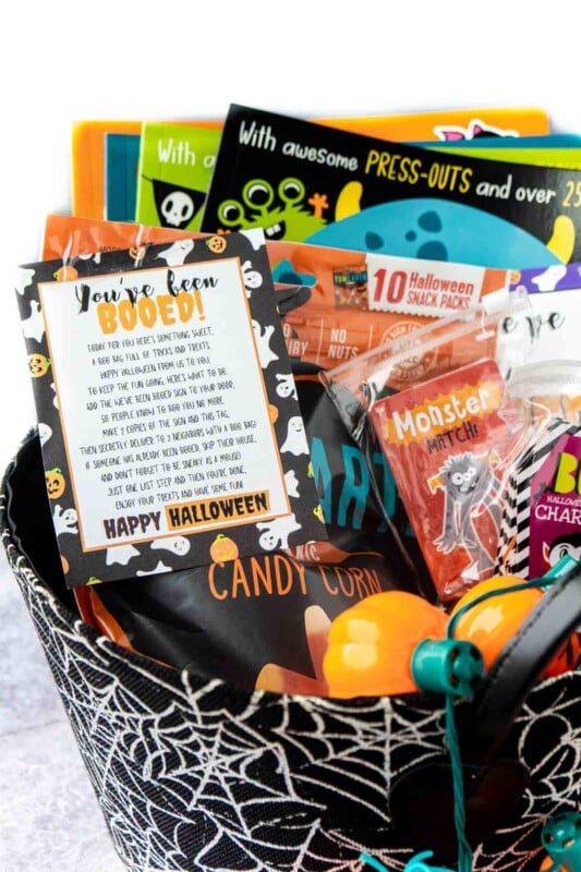 Spiderweb basket filled with Halloween books, games, and a you've been booed sign