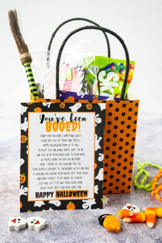 Black and orange polka dotted bag with a you've been booed sign and treats