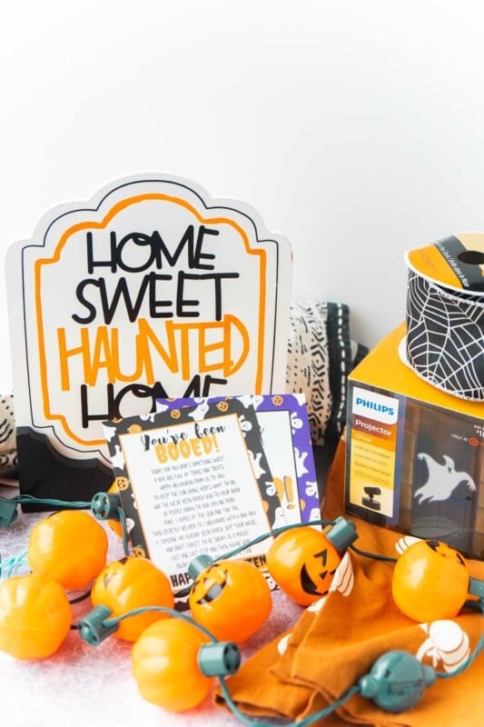 Home sweet haunted home sign, pumpkin lights, and a you've been booed sign