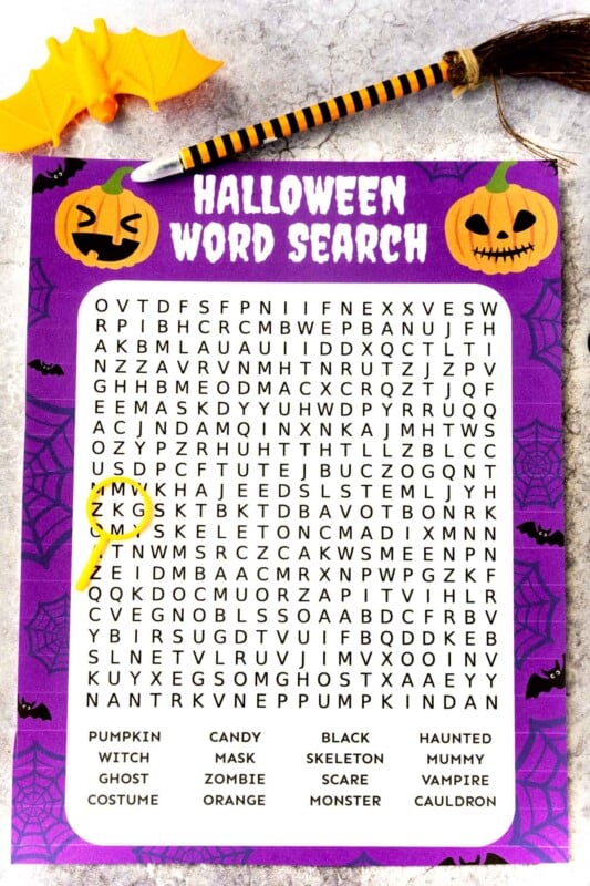 Printed out Halloween word search with a plastic bat and pen