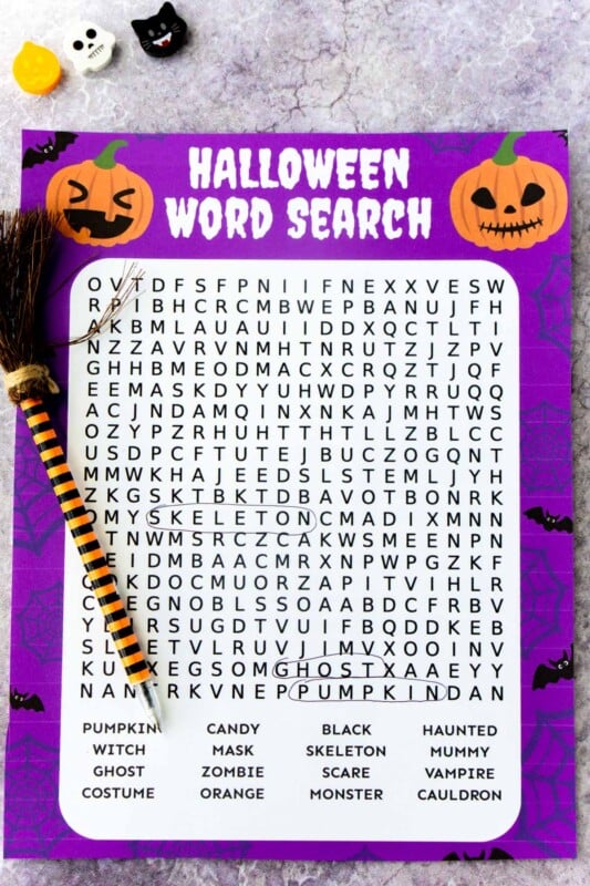 Printed out Halloween word search with a witch pen